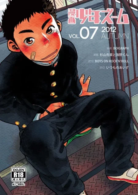 Joven ruborizado con uniforme escolar negro y curita en la mejilla sentado con las piernas abiertas y el pene erecto.
